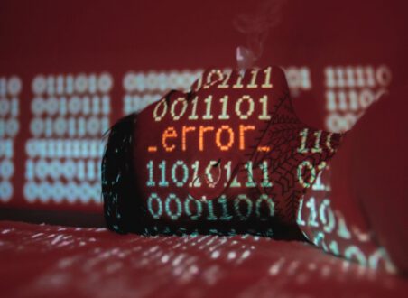 A hardhat covered by projected binary code and an error message