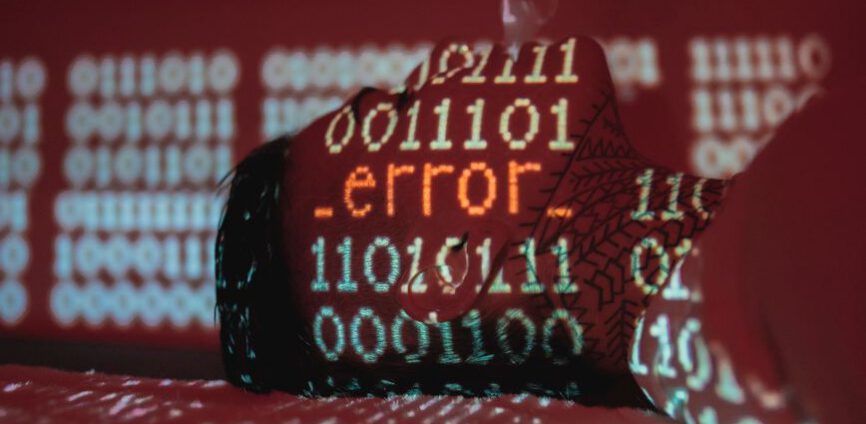 A hardhat covered by projected binary code and an error message