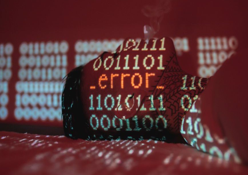 A hardhat covered by projected binary code and an error message