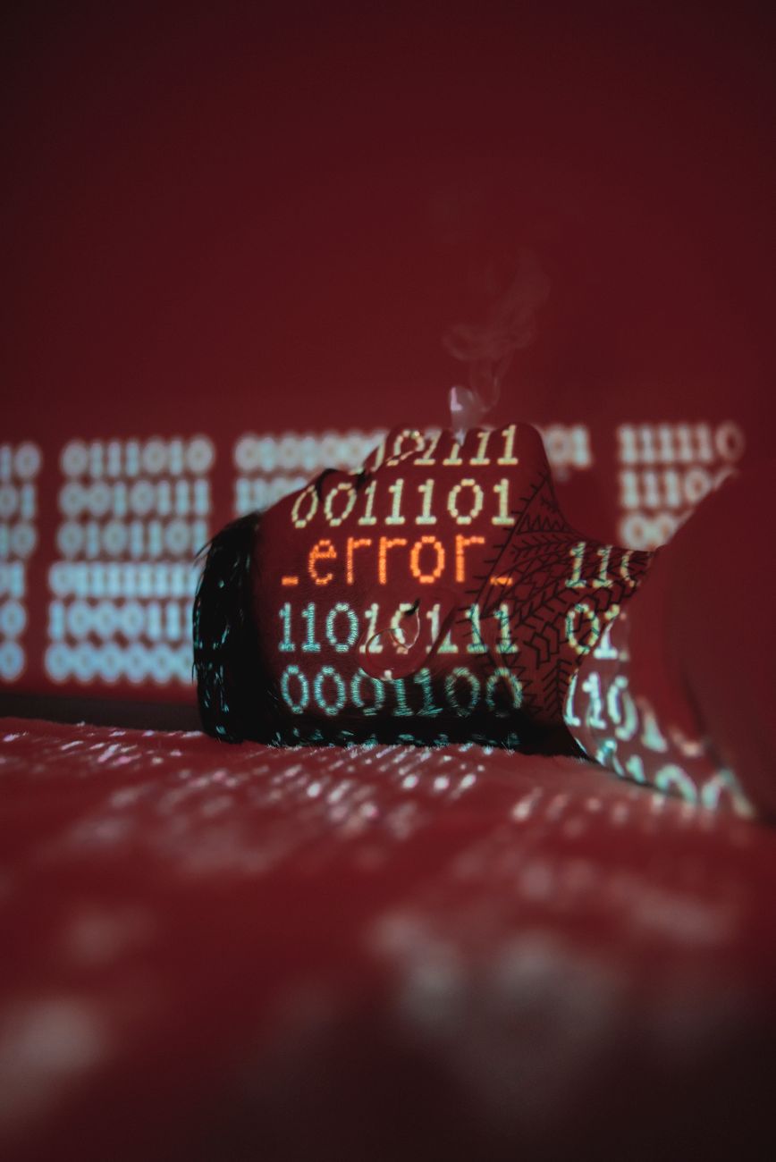 A hardhat covered by projected binary code and an error message
