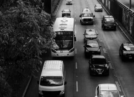 Black-and-white overhead view of traffic moving through an urban road