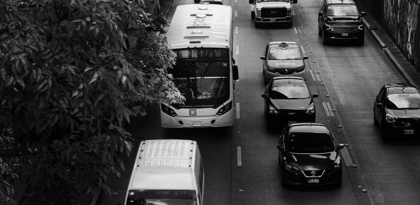Black-and-white overhead view of traffic moving through an urban road