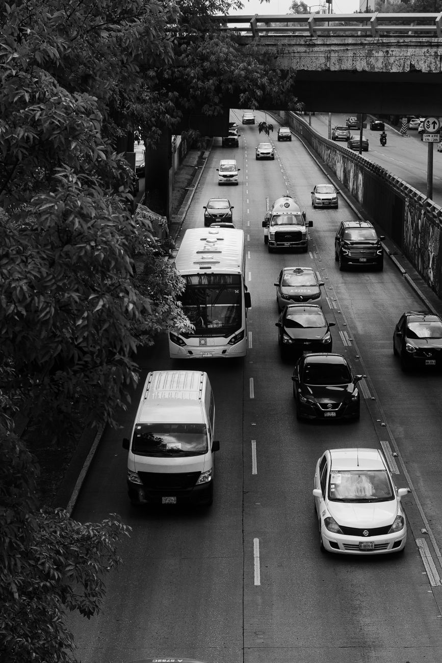 Black-and-white overhead view of traffic moving through an urban road